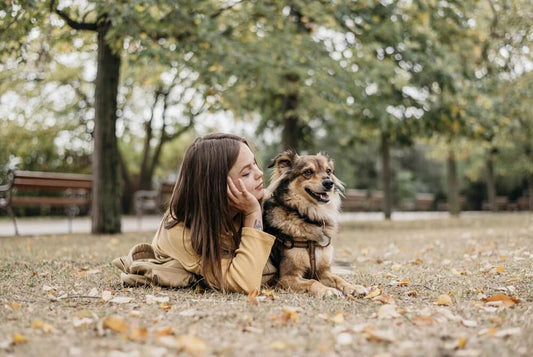pretty young woman petting her dog after a walk