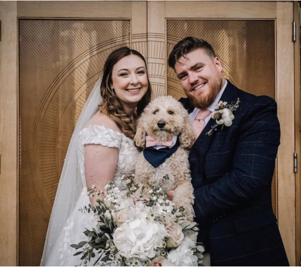 Wedding portrait family with a cute dog wearing a cute wedding outfit for dogs